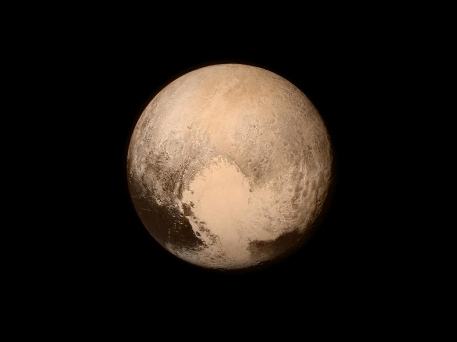An in-color photo of Pluto featuring its heart-shaped ocean.