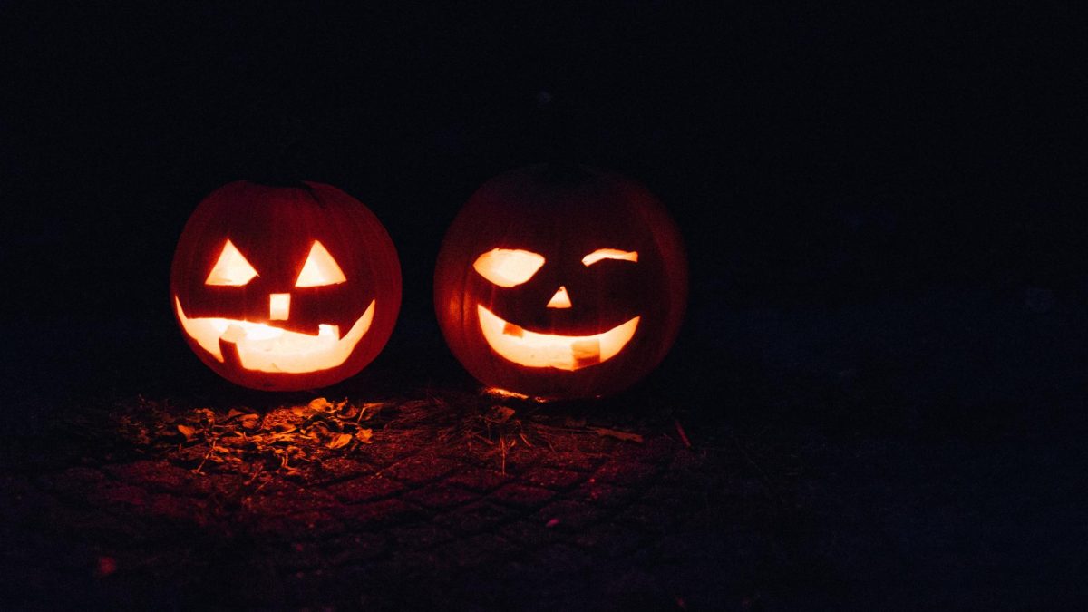 Photo of Two Lighted Jack-O-Lanterns During Night Time
